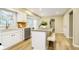 Well-lit kitchen featuring white cabinets, stainless steel appliances, and a center island at 10245 Briar Creek Ln, Carmel, IN 46033