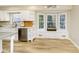 Cozy kitchen featuring white cabinets, stainless steel appliances, and a bright breakfast nook at 10245 Briar Creek Ln, Carmel, IN 46033