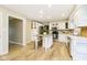 Updated kitchen features white cabinetry, stainless steel appliances, and a center island with seating at 10245 Briar Creek Ln, Carmel, IN 46033