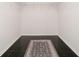 Empty walk-in closet space with black tile floors, a rug and wire shelving at 10245 Briar Creek Ln, Carmel, IN 46033