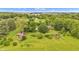 Expansive aerial view of a beautiful property surrounded by lush greenery and mature trees at 10444 N State Road 9, Fountaintown, IN 46130