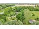 A winding gravel driveway is showcased on this expansive lot filled with mature trees and shrubs at 10444 N State Road 9, Fountaintown, IN 46130