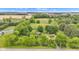 Aerial view of the home surrounded by mature trees and landscaping at 10444 N State Road 9, Fountaintown, IN 46130