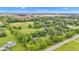 Aerial view of the home surrounded by mature trees and landscaping on a sunny day at 10444 N State Road 9, Fountaintown, IN 46130