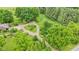 Lush trees surround a gravel driveway leading up to the home on this expansive property at 10444 N State Road 9, Fountaintown, IN 46130
