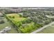 Aerial view of the home surrounded by mature trees and landscaping with property outline at 10444 N State Road 9, Fountaintown, IN 46130