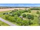 Aerial view of the home surrounded by lush trees, landscaping and land at 10444 N State Road 9, Fountaintown, IN 46130