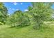 Spacious backyard with mature trees, offering a private and natural outdoor space at 10444 N State Road 9, Fountaintown, IN 46130