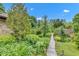 Beautifully landscaped backyard featuring a stone path and mature greenery at 10444 N State Road 9, Fountaintown, IN 46130
