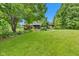 Expansive backyard with well-maintained lawn and home exterior, ideal for outdoor living at 10444 N State Road 9, Fountaintown, IN 46130