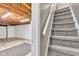 View of the basement stairs and unfinished basement area with exposed ceiling and open layout at 10444 N State Road 9, Fountaintown, IN 46130