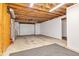 Unfinished basement area with concrete flooring, exposed ductwork, and utility connections at 10444 N State Road 9, Fountaintown, IN 46130