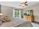 Bedroom view with a ceiling fan, large window, and light-colored walls overlooking an expansive green backyard at 10444 N State Road 9, Fountaintown, IN 46130