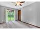 Bright bedroom with neutral tones, a sliding glass door, and plush carpet at 10444 N State Road 9, Fountaintown, IN 46130