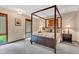 Charming bedroom with a four-poster bed and natural light streaming through the window at 10444 N State Road 9, Fountaintown, IN 46130