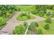 Bird's eye view of a circular gravel driveway framed by verdant trees and manicured gardens at 10444 N State Road 9, Fountaintown, IN 46130