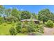 Aerial view of the home surrounded by mature trees and landscaping at 10444 N State Road 9, Fountaintown, IN 46130