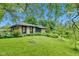 Picturesque home showcasing stone facade, mature trees and verdant lawn at 10444 N State Road 9, Fountaintown, IN 46130