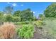 Scenic property with lush garden and partial home view, showing the property's natural setting at 10444 N State Road 9, Fountaintown, IN 46130