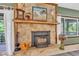 Charming stone fireplace with wooden mantle and decorative accents at 10444 N State Road 9, Fountaintown, IN 46130