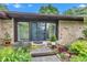 Inviting home entrance with stone details and lush landscaping around walkway at 10444 N State Road 9, Fountaintown, IN 46130