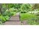 Path through lush greenery and gardens, showcasing the property's natural beauty at 10444 N State Road 9, Fountaintown, IN 46130