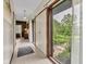 Hallway showcasing neutral tiles, view to outdoors, and open floorplan at 10444 N State Road 9, Fountaintown, IN 46130