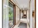 Hallway featuring neutral tiles, natural light, and access to multiple rooms at 10444 N State Road 9, Fountaintown, IN 46130