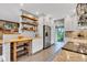 Kitchen boasts wood shelves, granite countertops, stainless steel refrigerator, and outdoor views at 10444 N State Road 9, Fountaintown, IN 46130