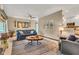 Comfortable living room with a blue sofa, unique wood coffee table, and plenty of natural light at 10444 N State Road 9, Fountaintown, IN 46130