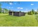 Exterior of outbuilding surrounded by lush green lawn on a sunny day at 10444 N State Road 9, Fountaintown, IN 46130