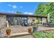 Charming patio with stone accents features comfortable seating and lush planters around perimeter at 10444 N State Road 9, Fountaintown, IN 46130