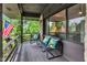 Covered porch with seating and peaceful view of the outdoor nature at 10444 N State Road 9, Fountaintown, IN 46130