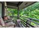 Covered porch featuring patio seating and wooded backyard views at 10444 N State Road 9, Fountaintown, IN 46130