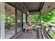 Relaxing covered porch with wooded backyard view and sliding door entrance at 10444 N State Road 9, Fountaintown, IN 46130