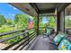 Inviting covered porch with outdoor seating and views of landscaped yard at 10444 N State Road 9, Fountaintown, IN 46130