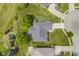 Top-down aerial perspective of a home with a backyard deck, surrounded by lush trees and a well-kept lawn at 10510 Inverness Ct, Fishers, IN 46037