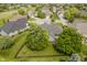 Aerial view of a charming home with mature landscaping, a fenced yard, and a serene neighborhood setting at 10510 Inverness Ct, Fishers, IN 46037