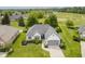 An aerial view showcasing the property's lush lawn, landscaping, and proximity to a golf course and neighboring homes at 10510 Inverness Ct, Fishers, IN 46037