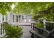 A spacious back deck with both Adirondack chairs, stools, and tables, along with a seating area with brown Adirondack chairs at 10510 Inverness Ct, Fishers, IN 46037