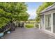 A back deck with views of the lush landscaping and a seating area with a fence outlining the backyard at 10510 Inverness Ct, Fishers, IN 46037