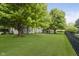 Lush green backyard with a modern deck and comfortable seating areas and landscaping at 10510 Inverness Ct, Fishers, IN 46037