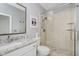 Bathroom showcasing a granite-topped vanity, a toilet, and a glass-enclosed shower with tiled walls at 10510 Inverness Ct, Fishers, IN 46037