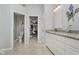 Bright bathroom with a granite countertop vanity, ceramic tile floor, and access to a walk-in closet at 10510 Inverness Ct, Fishers, IN 46037