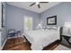 Bedroom with hardwood floors, ceiling fan, and a window with plantation shutters offering natural light at 10510 Inverness Ct, Fishers, IN 46037