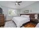Comfortable bedroom with a ceiling fan, a stylish rug, and a window with plantation shutters at 10510 Inverness Ct, Fishers, IN 46037