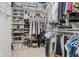 Walk-in closet featuring shelves for shoes and folded clothing and rods for hanging garments at 10510 Inverness Ct, Fishers, IN 46037