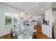 Charming dining area with a glass table, modern chandelier, and natural light from shuttered windows at 10510 Inverness Ct, Fishers, IN 46037