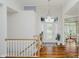 Elegant foyer with gleaming hardwood floors, a staircase and a stylish chandelier at 10510 Inverness Ct, Fishers, IN 46037