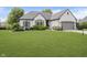Charming single-story home featuring a well-manicured lawn and a two-car garage, enhancing curb appeal at 10510 Inverness Ct, Fishers, IN 46037